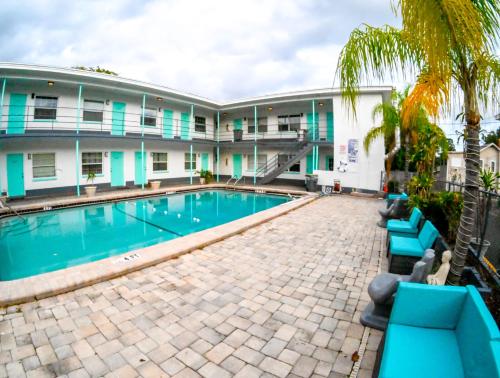a hotel with a swimming pool in front of a building at Uptown Inn & Suites in St. Petersburg