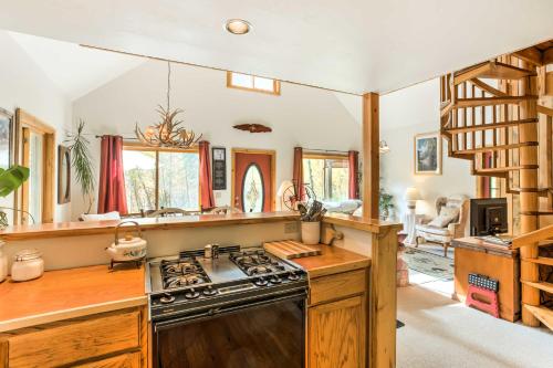 a kitchen with a stove top oven in a room at Marble Hideaway Cabin with Mountain Views and Deck! in Marble