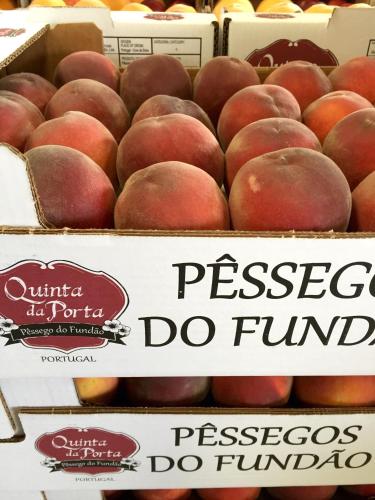 a bunch of boxes of peaches on display at a store at Quinta da Porta - Solar de Vale de Prazeres in Vale de Prazeres