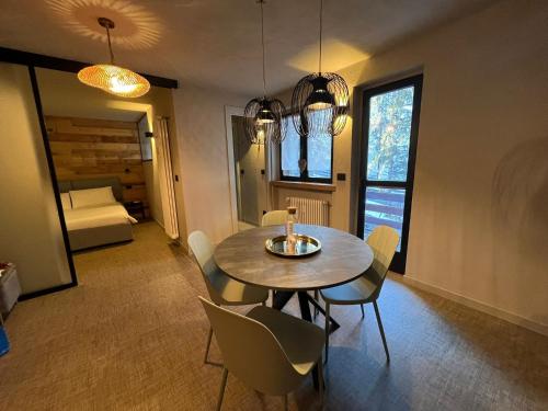 a dining room with a table and chairs and a bedroom at Fraiteve Suite in Sauze dʼOulx