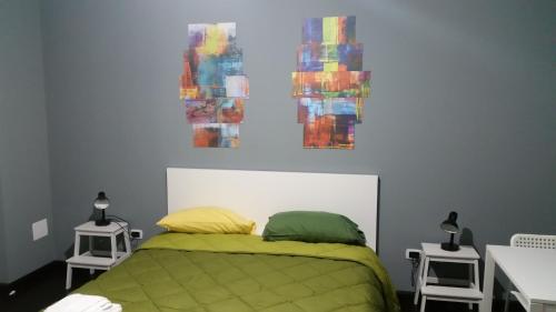 a bedroom with a green bed with two pillows at B&B Colors in Sellia Marina