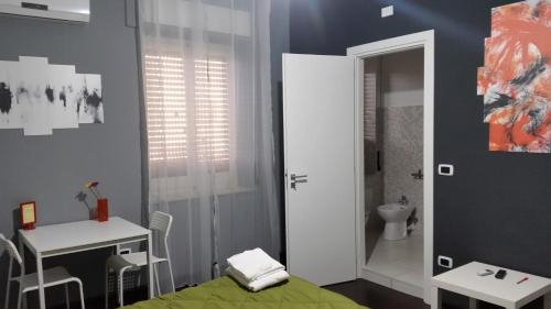 a bathroom with a bed and a sink and a toilet at B&B Colors in Sellia Marina