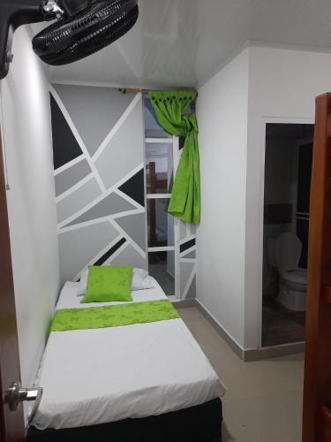 a bedroom with a bed with a shoe hanging above it at MIRADORES DEL PARAISO in Doradal