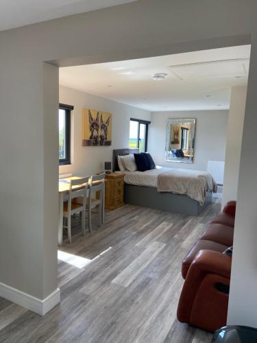 a bedroom with a bed and a dining room at Zara’s retreat in Doncaster