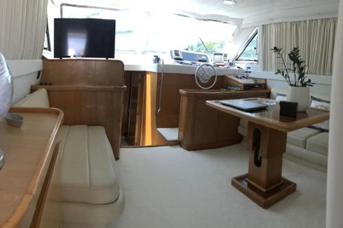 a small living room with a table and a couch at Motor yacht 45', 3 Cabins, 2 WC in Aegina Town