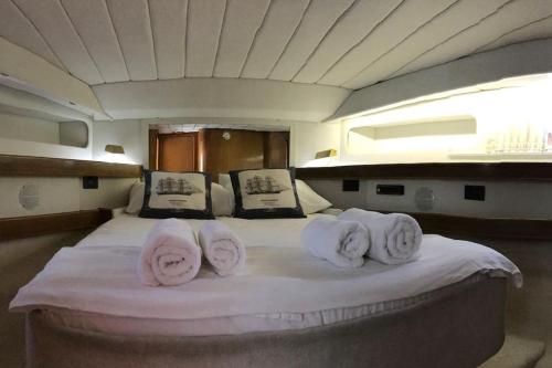 a bed on a boat with towels on it at Motor yacht 45' in Aegina Town
