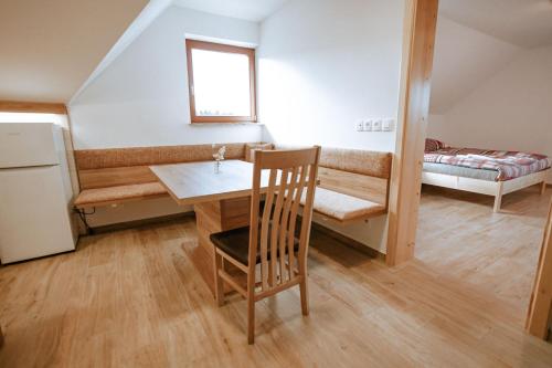 a small room with a table and a bed at Apartments Čenda in Železniki