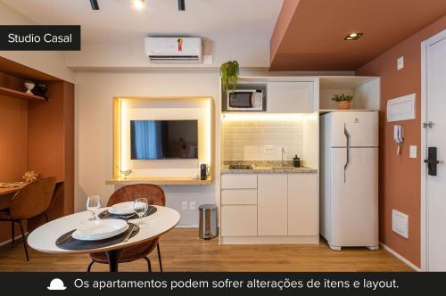 a small kitchen with a table and a refrigerator at Charlie Aeroporto Congonhas CGH in Sao Paulo