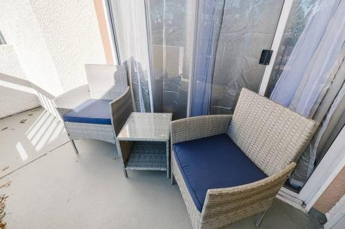 a balcony with chairs and a table on a balcony at Resort-like luxurious condo in Woodland Hills, Los Angeles, Pool, Hot-tub, and more in Woodland Hills
