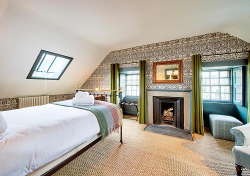 a bedroom with a bed and a fireplace at The Rock House - Main House in Edinburgh