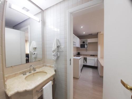 a bathroom with a sink and a mirror at EXCELENTE Flat junto aos Shoppings JK e Vila Olimpia in Sao Paulo