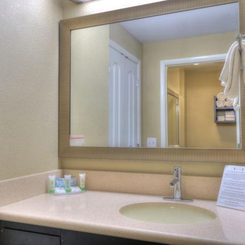 a bathroom with a sink and a large mirror at Staybridge Suites Knoxville West by IHG in Knoxville