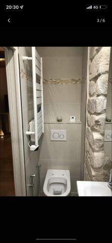 a small bathroom with a toilet and a sink at Jean-Marie in Paris