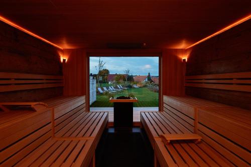 a room with benches and a window with a view at Landhotel Haringerhof mit Saunawelt und Naturbadeteich in Grafenhausen