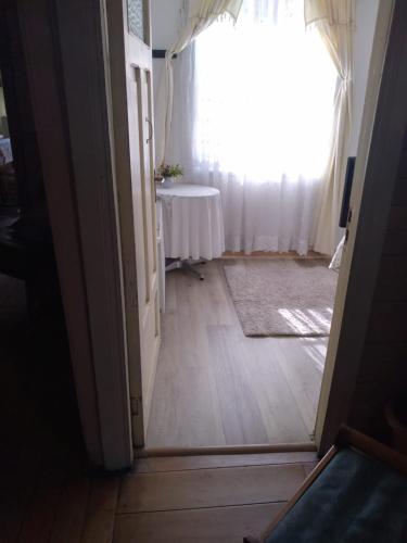 an open door to a room with a table and a window at Hostal Patrimonial Angelmó in Puerto Montt
