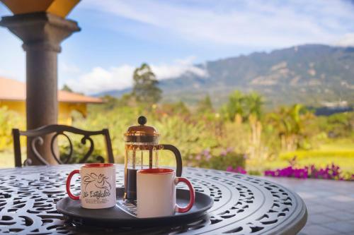 a table with two coffee mugs on top of it at Los Establos Boutique Resort - All Inclusive in Boquete
