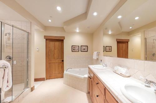 a bathroom with two sinks and a tub and a shower at Westridge 11 in Ketchum