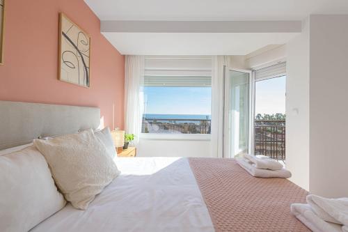 a bedroom with a bed and a large window at Juan Valera - Bellavista in Málaga
