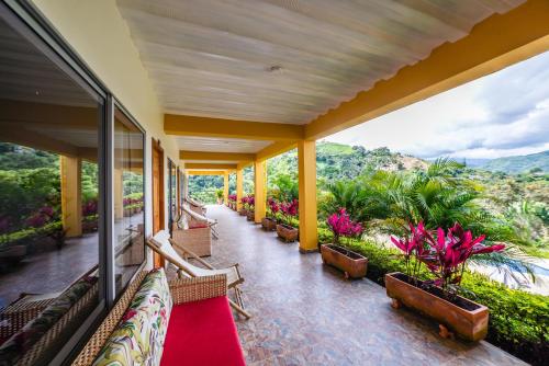 a balcony with benches and plants on a building at Tambo Eco Hotel in La Vega