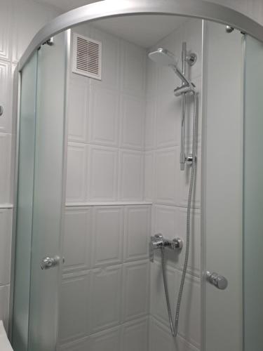 a shower with a glass door in a bathroom at Osiakówka in Szklarska Poręba