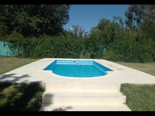a swimming pool in the middle of a yard at El puesto in Lobos