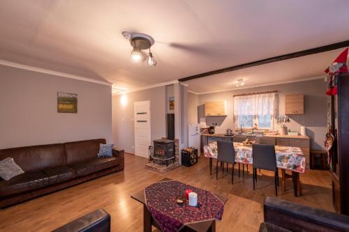 a living room with a couch and a table at Domek bez zegara in Lądek-Zdrój