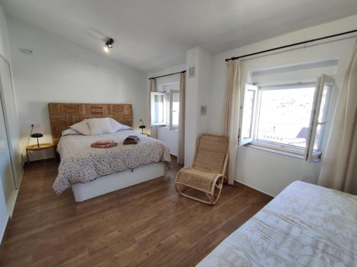 - une chambre avec un lit, une chaise et une fenêtre dans l'établissement Casa Cerro Luna, à Constantina