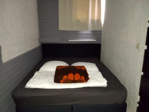 a small bed with a pillow on top of it at Zen'Ny in Hotton