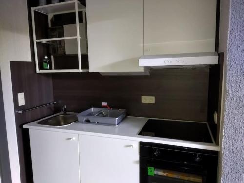 a kitchen with a sink and a microwave at Zen'Ny in Hotton