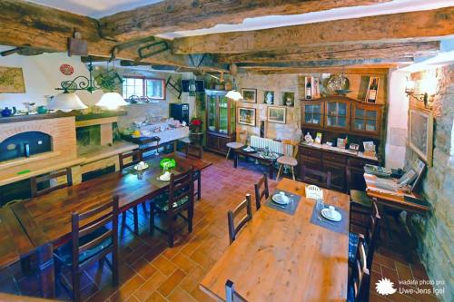 an overhead view of a dining room and kitchen with wooden tables and chairs at al Merlo Olivo, rural istrian house in Buje