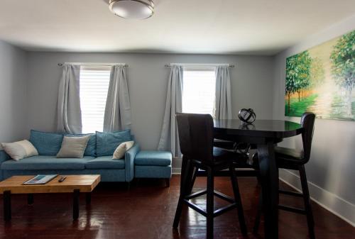a living room with a table and a couch at Cozy 2 Bedroom Home Minutes from Beach & Bars in Jacksonville Beach