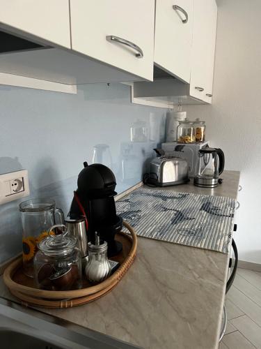 a kitchen counter with a tray with a coffee maker on it at SPRITZ HOME in Viddalba