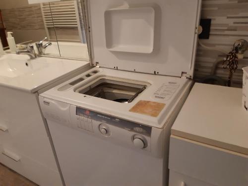 a white refrigerator with a stove in a kitchen at Giaveno, apartment "margherita" a pochi passi dal centro, wifi in Giaveno