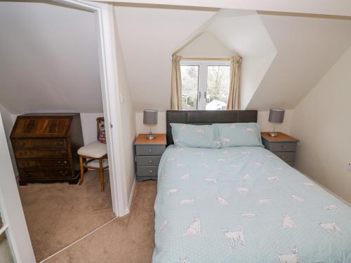 a bedroom with a bed and a desk and a window at Stonehaven in Kidderminster