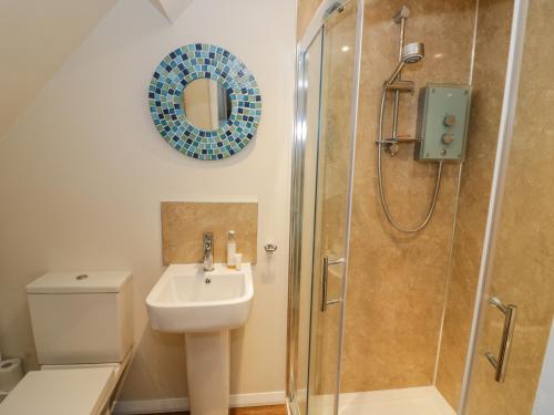 a bathroom with a shower and a sink and a toilet at Stonehaven in Kidderminster