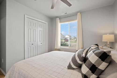a white bedroom with a bed and a window at Spacious Cool Springs! Central Nampa 3 Bed in Nampa