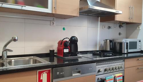 a kitchen with a sink and a counter top at Sweethome in Lisbon