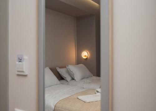 a reflection of a bed with white pillows in a mirror at Vila Muslli in Korçë