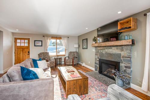 a living room with a couch and a fireplace at Lakeshore Vermont in Colchester