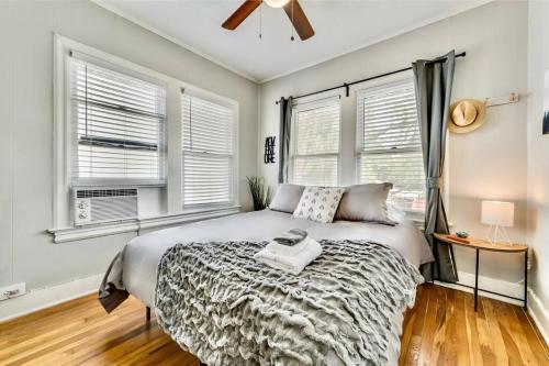 a bedroom with a bed and two windows at The Dreamy Escape on Lower Greenville in Dallas