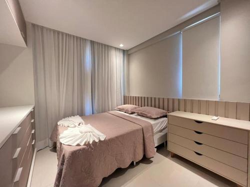 a bedroom with a bed and a dresser in it at ECO RESORT PRAIA DOS CARNEIROS - Desfrute de uma estadia inesquecível in Tamandaré