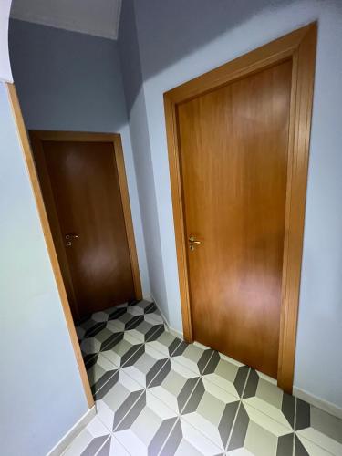 a room with two doors and a tiled floor at Bell'e Buono vicino aeroporto di Capodichino in Naples