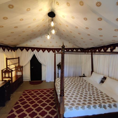 a bedroom with a canopy bed with a ceiling at Exotic Stay - a unique experience in Pune