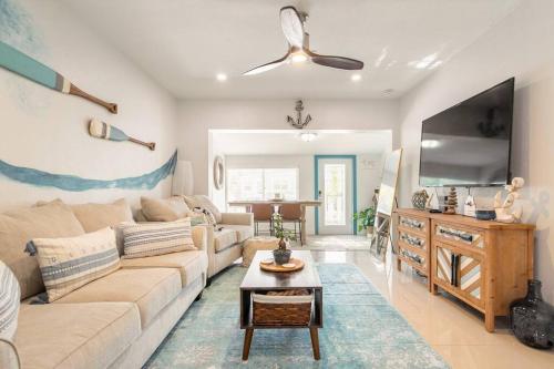 a living room with a couch and a tv at Central Nautical Themed 4 bed 2 bath Home in Fort Lauderdale