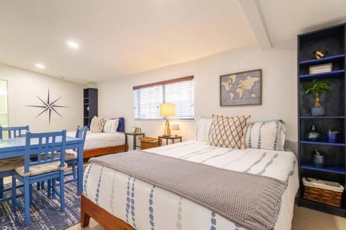 a bedroom with a bed and a table and a couch at Central Nautical Themed 4 bed 2 bath Home in Fort Lauderdale