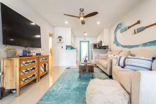 a living room with a couch and a flat screen tv at Central Nautical Themed 4 bed 2 bath Home in Fort Lauderdale