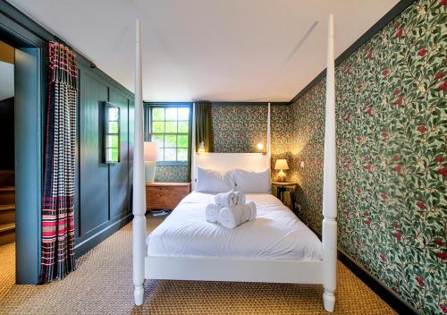 a bedroom with a bed with two teddy bears on it at Rock House - Photographer's Studio - Historic Gem in the heart of the City in Edinburgh