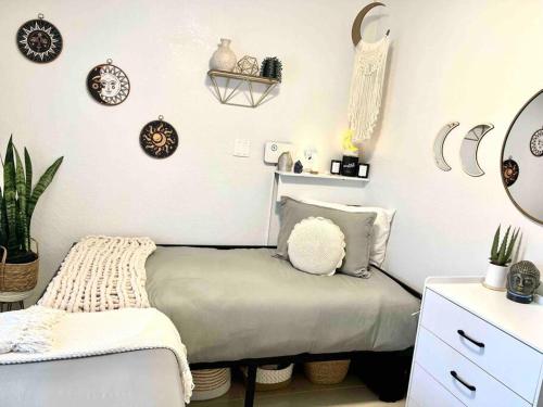 a small bedroom with a bed and a mirror at Central Nautical Themed 4 bed 2 bath Home in Fort Lauderdale