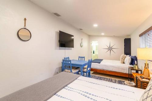 a bedroom with a bed and a table and a couch at Central Nautical Themed 4 bed 2 bath Home in Fort Lauderdale