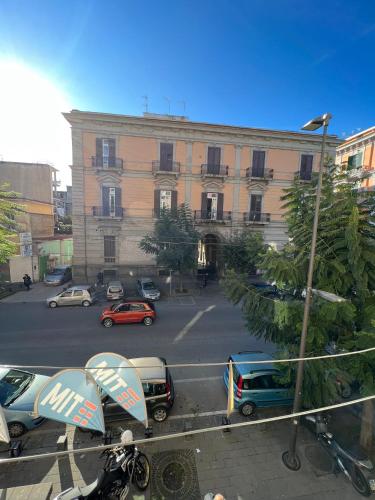 a large building with cars parked in a parking lot at Bell'e Buono vicino aeroporto di Capodichino in Naples
